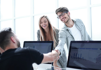 Wall Mural - Businesspeople shaking hands against room with large window loo