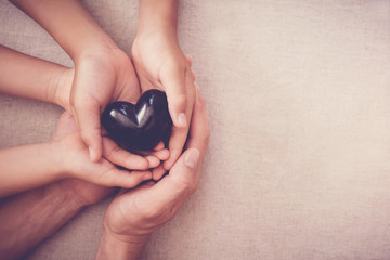 hands and red heart, health insurance, mending broken family, mental illness health, black lives matter, no racism concept