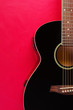 © yrafoto - Acoustic guitar on red background