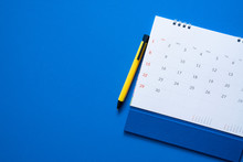 Close Up Of Calendar On The Blue Table Background, Planning For Business Meeting Or Travel Planning Concept