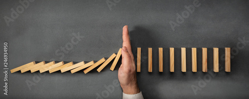 Cuadros en Lienzo Chain Reaction In Business Concept, Businessman Intervening Dominoes Toppling