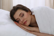 © rogerphoto - Beautiful young woman sleeping while lying in her bed. Concept of pleasant and rest reinstatement for active life