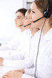 © rogerphoto - Call center operators. Focus at beautiful woman in headset