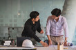 © Songsak C - Image of engineer meeting for architectural project working with partner and engineering tools on workplace.