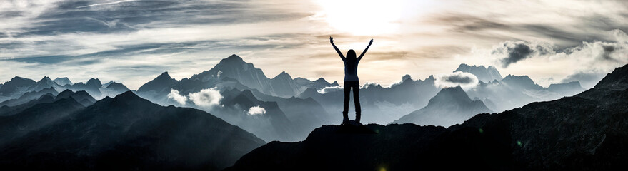 Woman standing at a summit