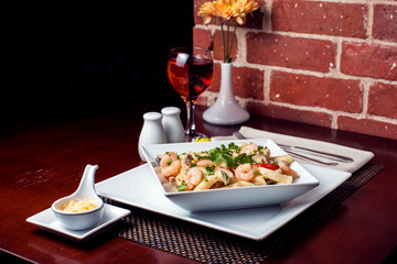 Wall Mural - Penne (pasta) with shrimps/prawns and sausage in pomodoro (tomato) sauce - Italian cuisine, cooking, culinary (traditional authentic taste). Food and restaurant concept