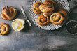 © Natasha Breen - Variety of homemade puff pastry buns cinnamon rolls and croissant served with jam, butter as breakfast over blue texture background. Flat lay, space