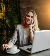 Young business woman working in cafe