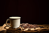 Fototapeta Mapy - Cup of coffee and coffee beans on black background