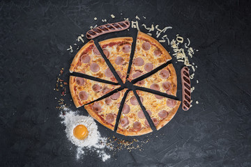 Wall Mural - Tasty pizza with sausage on black background