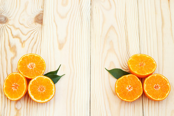 Creative orange background. Slices of citrus fruits on a wooden background. Summer background. Copy space.