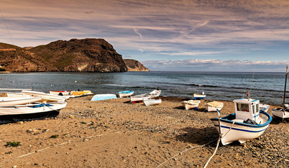 Wall Mural - Mediterranean beach with fishing boats ashore in Cabo de Gata park in Almeria, southern Spain.