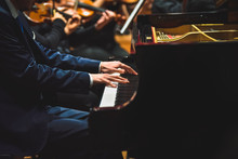Pianist Playing A Piece On A Grand Piano At A Concert, Seen From The Side.