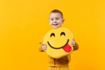 Wall Mural - Little cute kid boy 3-4 years old wearing yellow clothes isolated on bright orange wall background, children studio portrait. People sincere emotions, childhood lifestyle concept. Mock up copy space.