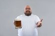 © Yakobchuk Olena - Waist up of fat bearded man looking friendly and offering beer