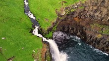 Aerial View Above Of Múlafossur Waterfall Near A Small Village, Faroe Island.