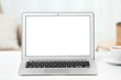 © New Africa - Laptop with blank screen on table indoors. Space for text