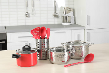 Wall Mural - Set of clean cookware and utensils on table in kitchen