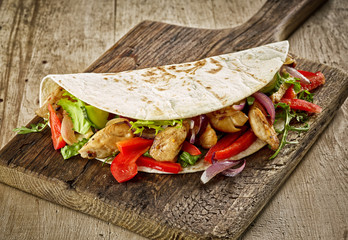 Canvas Print - Tortilla wrap with fried chicken meat and vegetables