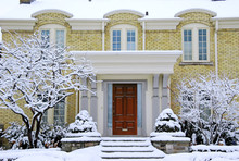 Brick House With Snow Covered Steps