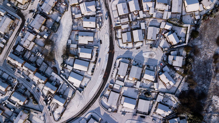 Wall Mural - Top down aerial view of a Welsh town covered in fresh white snow (Ebbw Vale, Wales, UK)
