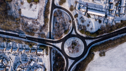 Wall Mural - Aerial drone view of a traffic roundabout surrounded by fresh snowfall (Ebbw Vale, Wales, UK)