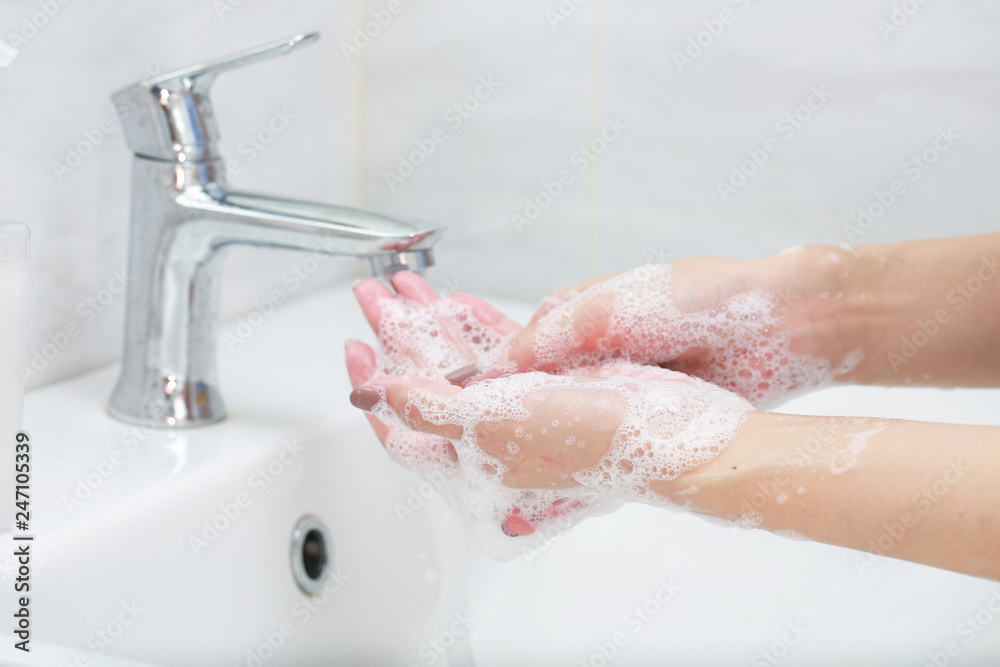 Washing hands with soap under the faucet with water. - obrazy, fototapety, plakaty 