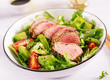 Tuna salad. Japanese traditional salad with pieces of medium-rare grilled Ahi tuna and sesame with fresh vegetable on a bowl. Authentic Japanese food.