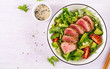 Tuna salad. Japanese traditional salad with pieces of medium-rare grilled Ahi tuna and sesame with fresh vegetable on a bowl. Authentic Japanese food. Top view