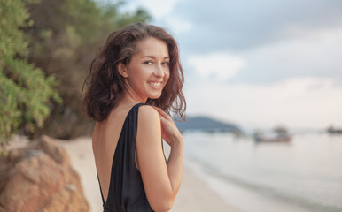 Wall Mural - portrait of a beautiful young woman with dark hair, on the beach, sensual portrait, natural beauty