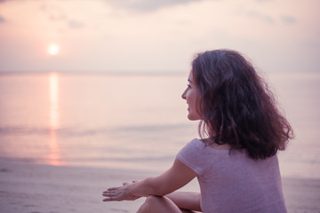 Wall Mural - young beautiful slim sensual woman looks at the sunset on the sea on the beach, beauty and fashion, 