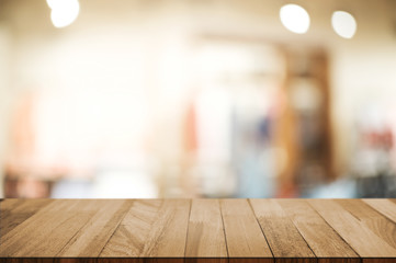 wood table in front of blur super market background.