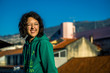 © bint87 - Portrait of young caucasian girl sitting on terrace above the rooftops of the Funchal city and enjoying the sunrise and new day. Madeira, Portugal.