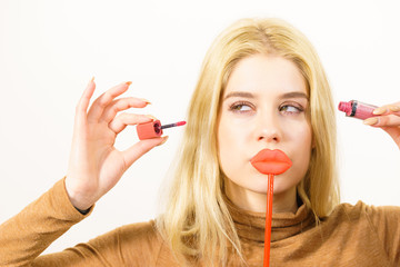 Poster - Woman applying lipstick or lip gloss