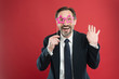 © be free - Perfect for corporate party. Handsome mature man wear fake glasses accessories. Funny businessman in party photobooth props. Elderly man enjoying party time. Photo booth party celebration