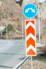 road signs on the road with a tunnel.