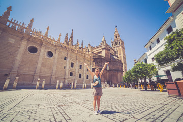 happy smiling girl tourist take photo selfie in Spain square (plaza de espana) in Sevilla, Spain