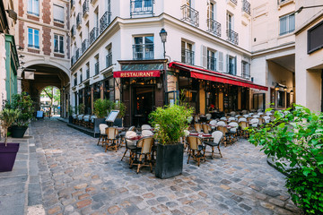 Wall Mural - cozy street near boulevard san-german with tables of cafe in paris, france. architecture and landmar