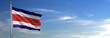 Bandera de Costa Rica subida ondeando al viento con cielo de fondo