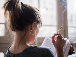 woman smoking and reading