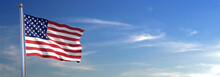 Flag Of United States Of America Rise Waving To The Wind With Sky In The Background