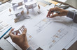 © Chaosamran_Studio - architect design working drawing sketch plans blueprints and making architectural construction model in architect studio