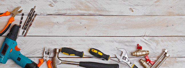 top view of set of hand tools on wooden background with copy space, suitable for header or banner