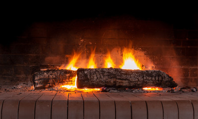 A glowing fire in the stone fireplace