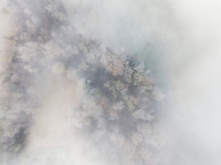  Aerial view of rural landscape in Switzerland covered with fog. Cold morning in winter with beautiful light.