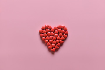 A heart shape of medicine pills on pink background. Concept of Valentine's Day or pharmacy, Medical.