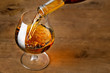 © alter_photo - brandy or cognac pouring into glass
