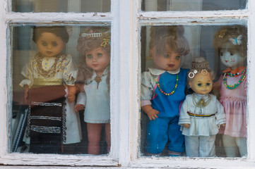 Puppets looking outside at an old window in Sibiu, Transilvanya 