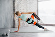 © MZaitsev - young woman practicing yoga in fitness studio