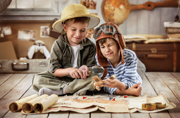 Boys in images traveler and pilot play in his room